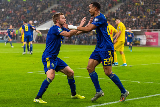 Sebastian Larsson and Robin Quaison of Sweden celebrate 0-2