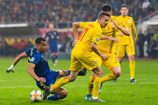 Robin Quaison of Sweden falls when competing fpr the ball