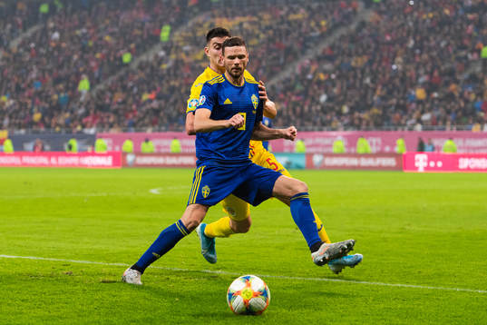 Marcus Berg of Sweden and Ionut Nedelcearu of Romania