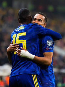 Alexander Isak and Robin Quaison of Sweden hug as they