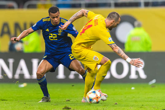 Robin Quaison of Sweden and Vasile Mogos of Romania compete