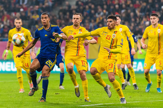 Robin Quaison of Sweden competes for the ball with Nicusor