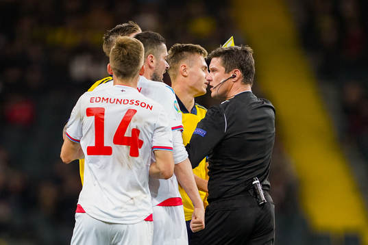 Mattias Svanberg of Sweden receives a yellow card
