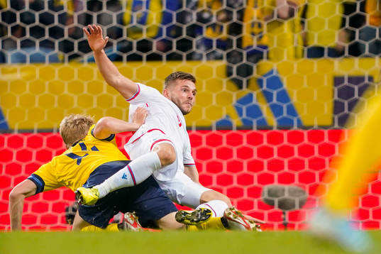 Filip Helander of Sweden tackles Gilli Rólantsson of Faroe