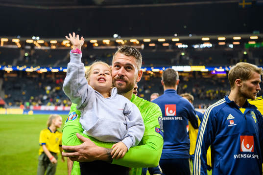 Goalkeeper Kristoffer Nordfeldt of Sweden with his daughter