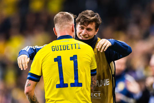 John Guidetti of Sweden celebrates scoring 3-0 and hugs