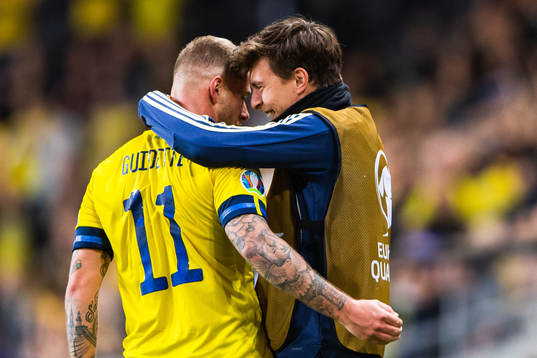 John Guidetti of Sweden celebrates scoring 3-0 and hugs