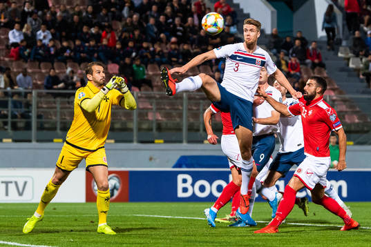 Goalkeeper Henry Bonello of Malta and Kristoffer Ajer of