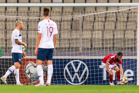 Paul Fenech of Malta picks up the ball