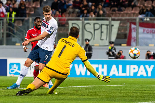 Alexander Sørloth of Norway scores 1-2 behind goalkeeper
