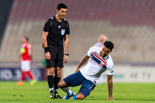 Referee Aliyar Aghayev see Joshua King of Norway sit down