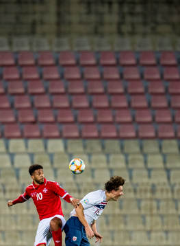 Kyrian Nwoko of Malta and Sander Berge of Norway