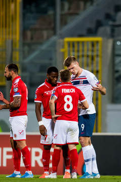 Alexander Sørloth of Norway argues with Paul Fenech of