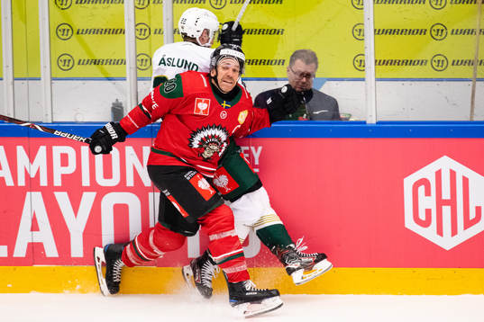 Joel Lundqvist of Frölunda hits Per Åslund of Färjestad