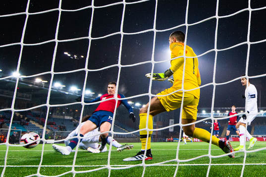 Jørgen Larsen of Norway scores 2-3 behind goalkeeper Diogo