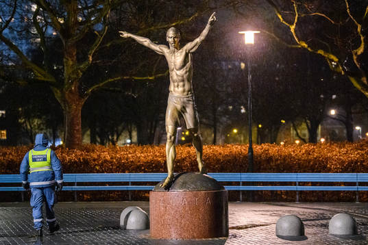 A steward is guarding the statue of Zlatan Ibrahimovic