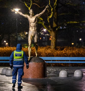 A steward is guarding the statue of Zlatan Ibrahimovic