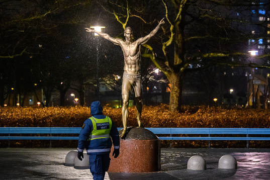A steward is guarding the statue of Zlatan Ibrahimovic