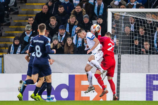 Artem Besedin of Dynamo Kiev tackles goalkeeper Johan