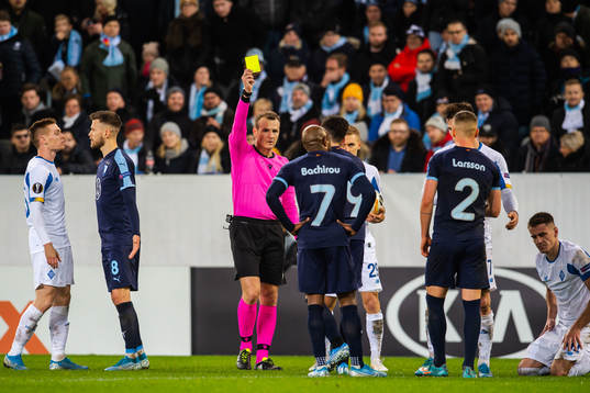 Erdal Rakip of Malmö FF is shown a yellow card by referee