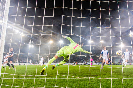 Markus Rosenberg of Malmö FF scores 4-3 behind goalkeeper