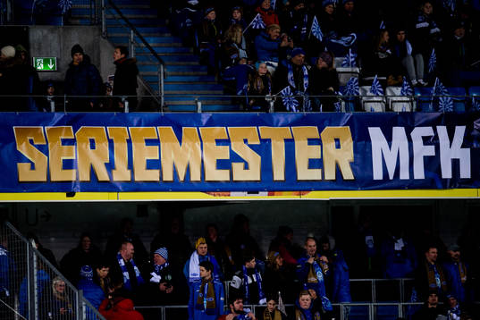 Spectators and a banner