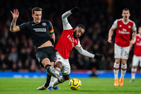 Lewis Dunk of Brighton and Alexandre Lacazette of Arsenal