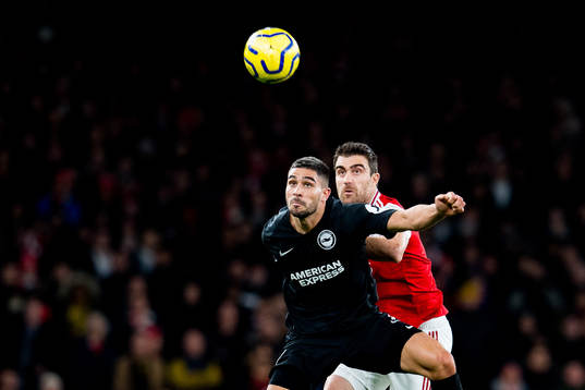 Neal Maupay of Brighton and Sokratis of Arsenal