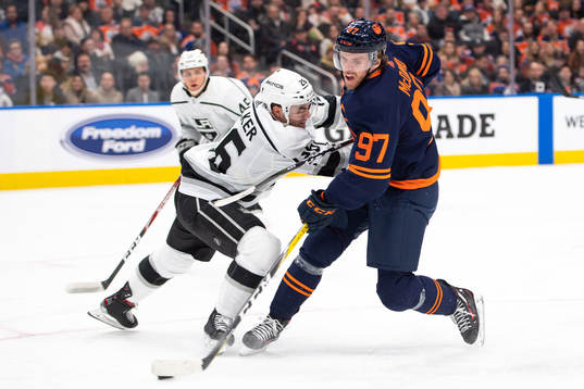 Sean Walker of the Los Angeles Kings and Connor McDavid of