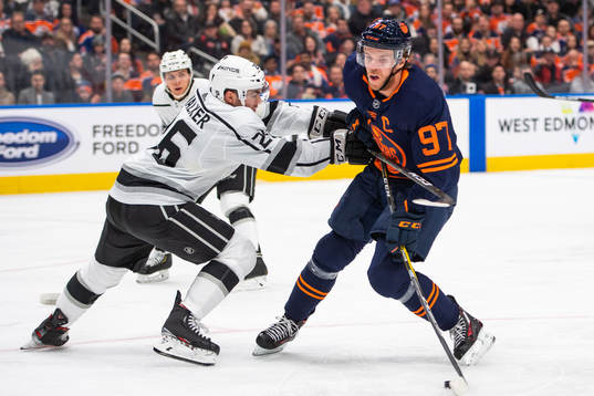 Sean Walker of the Los Angeles Kings and Connor McDavid of