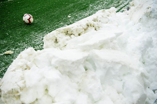 The official match ball next to the snow
