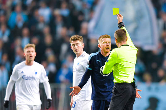 Anders Christiansen of Malmö FF receives a yellow card