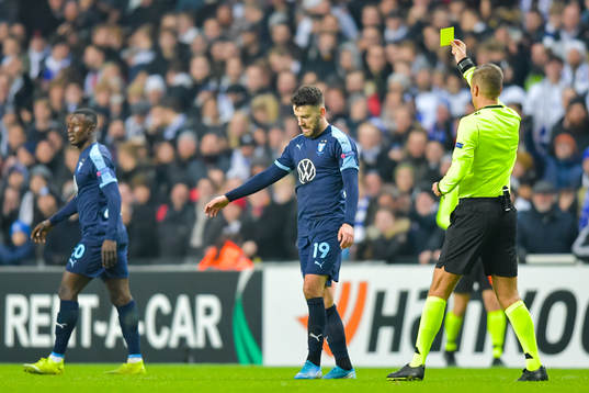 Erdal Rakip of Malmö FF receives a yellow card from