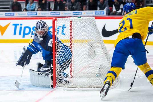 Nils Höglander of Sweden scores 1-1 behind goalkeeper