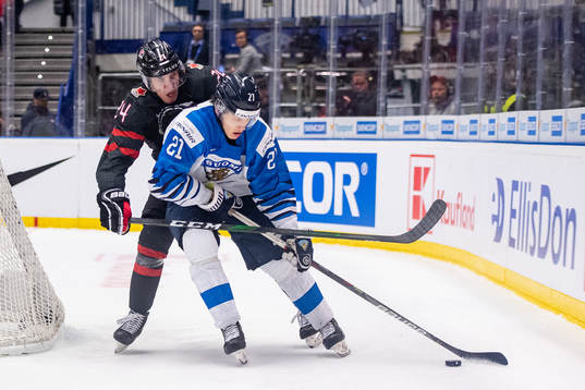 Ty Smith of Canada and Patrik Puistola of Finland