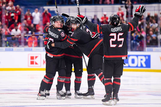 Ty Dellandrea, Kevin Bahl and Aidan Dudas celebrate the 1-0