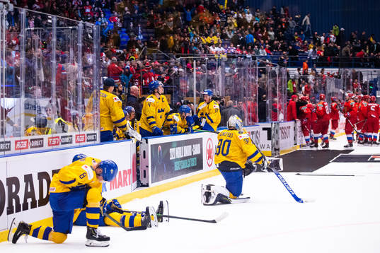 Adam Ginning and goalkeeper Hugo Alnefelt of Sweden look