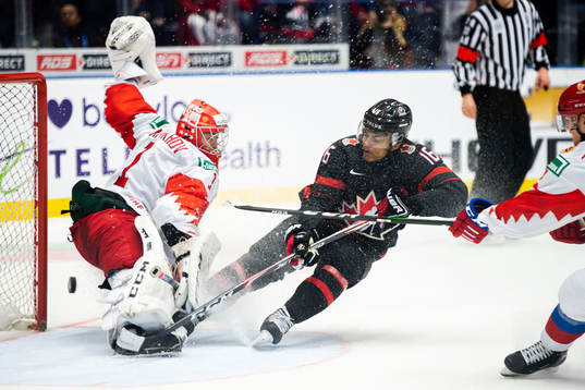 Akil Thomas of Canada scores 4-3 behind goalkeeper Amir