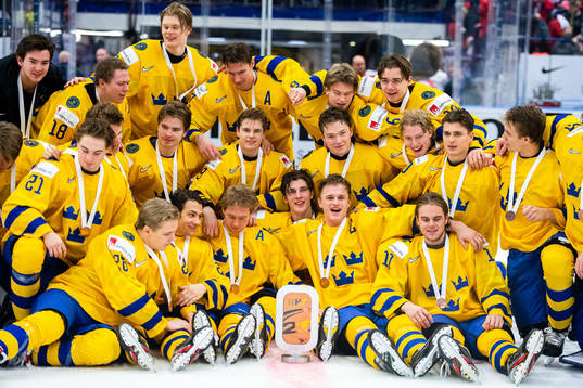 Players of Sweden celebrate with the trophy
