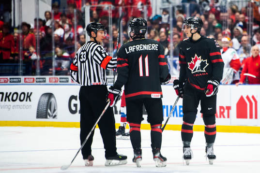 Alexis Lafreniere and Dylan Cozens of Canada in a