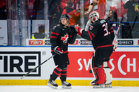 Connor McMichael and goalkeeper Joel Hofer of Canada