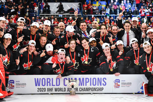 Players of Canada celebrate with the trophy and their medals