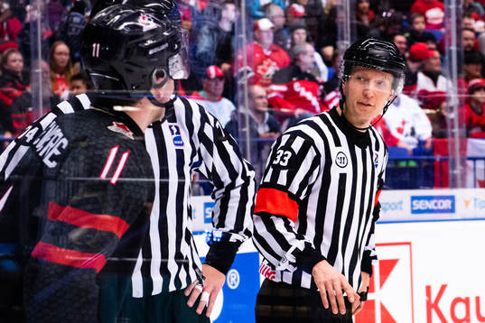 Alexis Lafreniere of Canada referee Kristian Vikman and