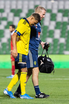 Jordan Larsson of Sweden receives help to leave the pitch