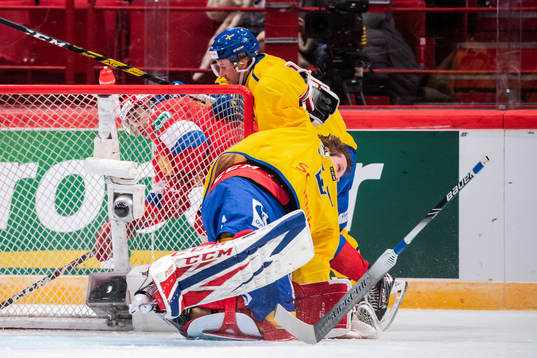 Goaltender Lars Johansson of Sweden in a collision with