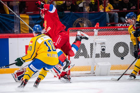 Artur Kayumov of Russia in a collision with goaltender Lars