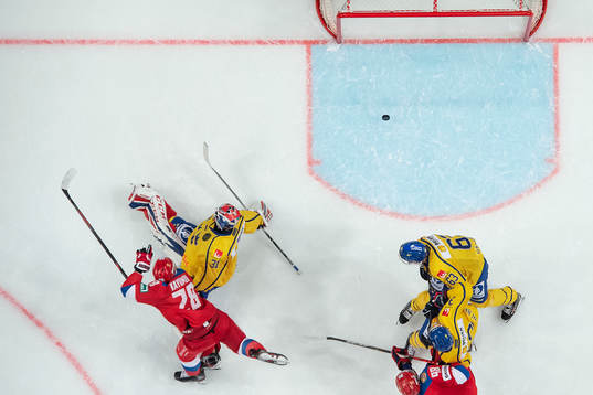 Artur Kayumov of Russia in a collision with goaltender Lars