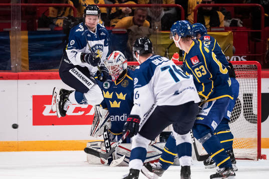 Teemu Pulkkinen of Finland and goaltender Magnus Hellberg