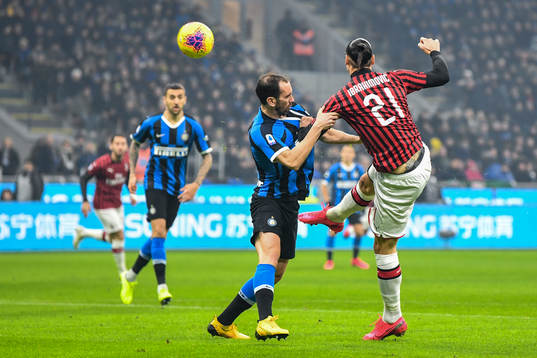 Zlatan Ibrahimovic of Milan and Diego Godin of Inter