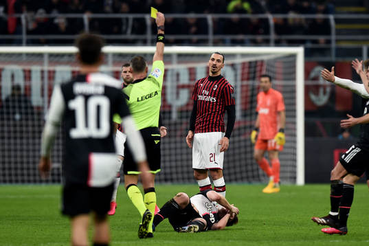 Zlatan Ibrahimovic of AC Milan receives a yellow card